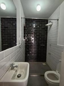a bathroom with a sink and a toilet at Luxe Studio Kinoo in Rungiri +12 photos
