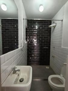 a bathroom with a sink and a toilet at Luxe Studio Kinoo in Rungiri