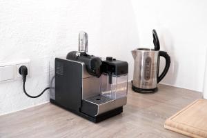 希尔波尔特施泰因Antikperle mit Komfort的咖啡壶,放在搅拌机旁边的柜台上