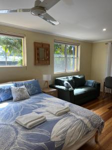 ウールグールガにあるSafety Beach Bungalowsのベッドとソファと窓のある寝室