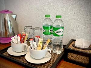 a tray with two bottles of water and two cups at AMORA Lanta in Ko Lanta Yai