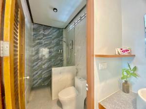 a bathroom with a toilet and a shower and a sink at AMORA Lanta in Ko Lanta Yai +19 photos