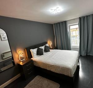 a bedroom with a large bed and a window at 2 Bedroom Flat Ground Floor Town Centre Colchester in Colchester