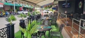 a row of tables and chairs in a restaurant at The Shamrock in Bang Sare +3 photos