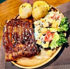 a plate of food with meat and vegetables on a table at The Shamrock in Bang Sare