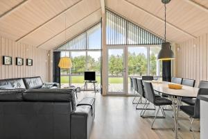a living room with a couch and a table with chairs at TV1459-Jerup-Aaensvej-11 in Jerup
