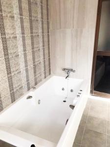 a white bath tub in a bathroom at 夢街道 in Fukuyama +59 photos