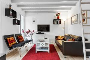 a living room with a couch and a red rug at AE248-Aeroskobing-Violstraede-16 in Ærøskøbing