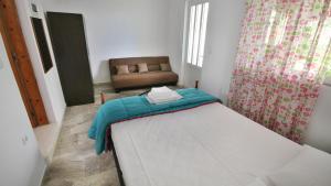 A bed or beds in a room at Ampelos apartment and studios