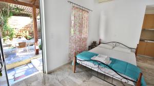 A bed or beds in a room at Ampelos apartment and studios