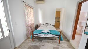 A bed or beds in a room at Ampelos apartment and studios