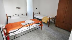 A bed or beds in a room at Ampelos apartment and studios