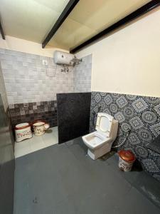 a bathroom with a toilet in a room at Ammara Eco Stays in Avathi