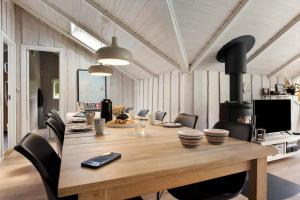 a dining room with a large wooden table and chairs at SB106-Sydals-Harresbaek-16 in Sarup