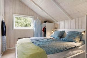a bedroom with a bed and a window at SB106-Sydals-Harresbaek-16 in Sarup