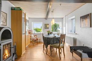 a dining room with a table and a fireplace at SB117-Nordborg-Oksbol-Sondergade-2 in Nordborg