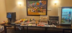 a buffet of food on a table next to a refrigerator at Posada Casona de la Ventilla in Laredo