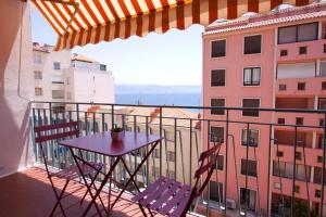 a table and chairs on a balcony with a view at Appartement plage du Trottel in Ajaccio