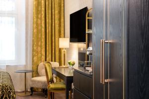 a kitchen with a desk and a refrigerator at Thon Hotel Vasa in Stockholm