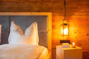 a bedroom with a bed with a pillow and a lamp at Kasermandl in Elbigenalp