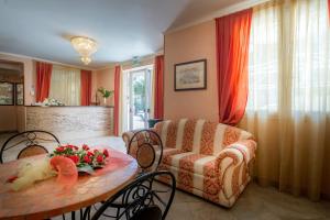 a living room with a table and a couch at Hotel Residence Amarcord in Rimini