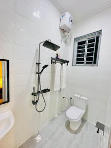a bathroom with a shower and a toilet and a sink at Sk homes Dodoma in Dodoma +5 photos