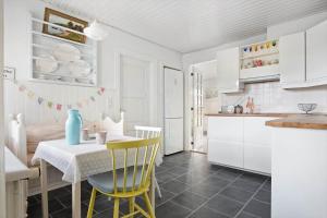 a kitchen with a table and yellow chairs in a room at TV1625-Albaek-Samsovej-10 in Ålbæk +19 photos