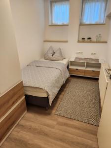 a small bedroom with two beds and a mirror at Winzerhof Düring in Iphofen +98 photos