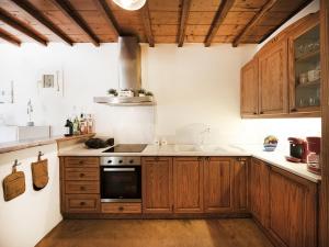 a kitchen with wooden cabinets and a stove top oven at Villa in Mykonos near Agios Sostis Beach in Agios Sostis Mykonos