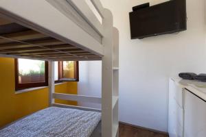 a bedroom with a bunk bed with a flat screen tv at Hostel Kvarner in Rijeka
