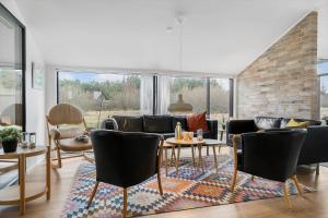 a living room with a couch and tables and chairs at TV1573-Albaek-Musvagevej-268 in Ålbæk +27 photos