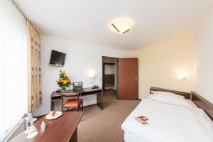 Postel nebo postele na pokoji v ubytování Hotel Strijewski