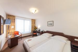 Postel nebo postele na pokoji v ubytování Hotel Strijewski