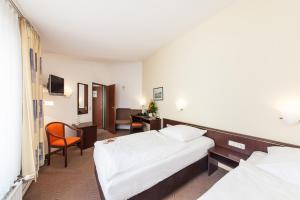 Postel nebo postele na pokoji v ubytování Hotel Strijewski