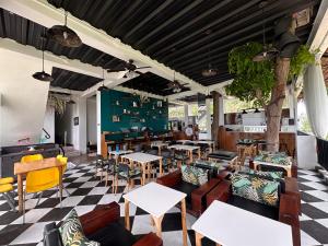 a restaurant with tables and chairs and a checkered floor at G Boutique Resort - Santander in Santander +39 photos