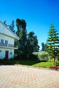 a house with a tree and a basketball hoop at Jevis daffodils in Ooty