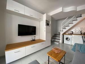 a living room with a flat screen tv on a wall at PLAYMAR Refugio Palmeras in Maspalomas