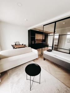a living room with a white couch and a chair at Neliapila's two-room apartment in Kokkola