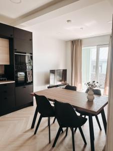 a dining room table and chairs in a kitchen at Neliapila's two-room apartment in Kokkola