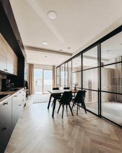 a dining room with a table and chairs in a kitchen at Neliapila's two-room apartment in Kokkola