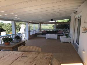 a screened in porch with a table and chairs at Villa in Sisi near Beach & Olive Groves in Milatos
