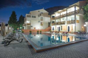 a hotel with a swimming pool in front of a building at Berg Apartments in Bar