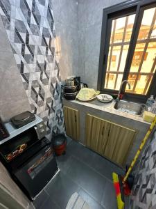 a small kitchen with a sink and an oven at Cristal in Adido Gomé