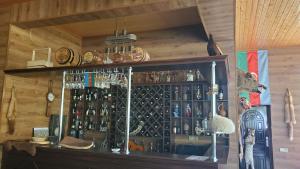 a bar with a bunch of bottles on a wall at Shahdag Mountain Hotel in Laza