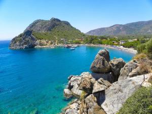 a view of a beach with rocks and the ocean at My Bungalov in Mesudiye