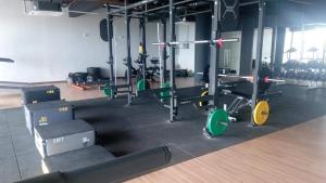 a gym with rows of exercise equipment in a room at Timurbay Seafront Kuantan Beach D'Sunset Ombak Samudera in Kuantan