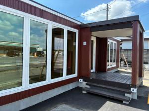 a porch of a building with windows on it at SMA MO inn Omitama in Omitama