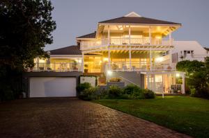 a large house with a balcony and a driveway at The Knysna Belle Guest House in Knysna