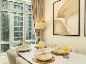 a dining room with a table with glasses of orange juice at Luxury Stay in Downtown-Steps to Burj & Dubai Mall in Dubai