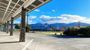 an empty parking lot with mountains in the background at Anchorage Motel Apartments in Te Anau
